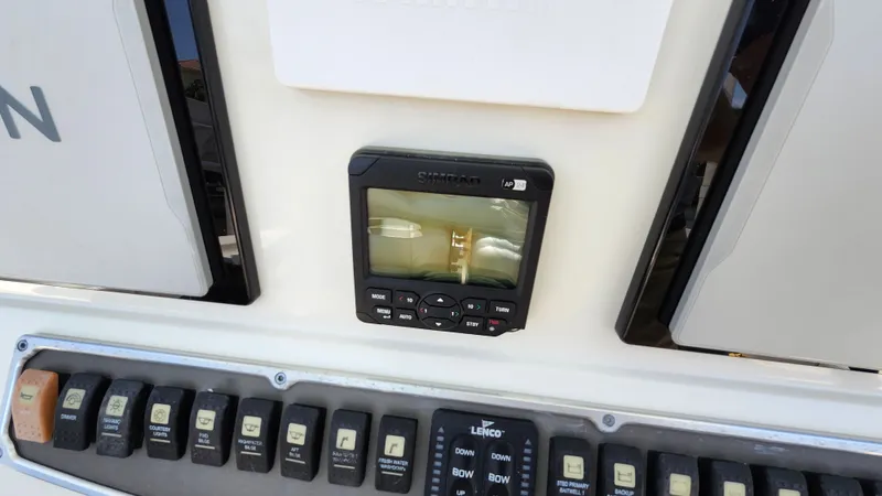 Slide: The Image of Hydra-Sports 3400 CC 2014 boat console with controls and switches. - 17