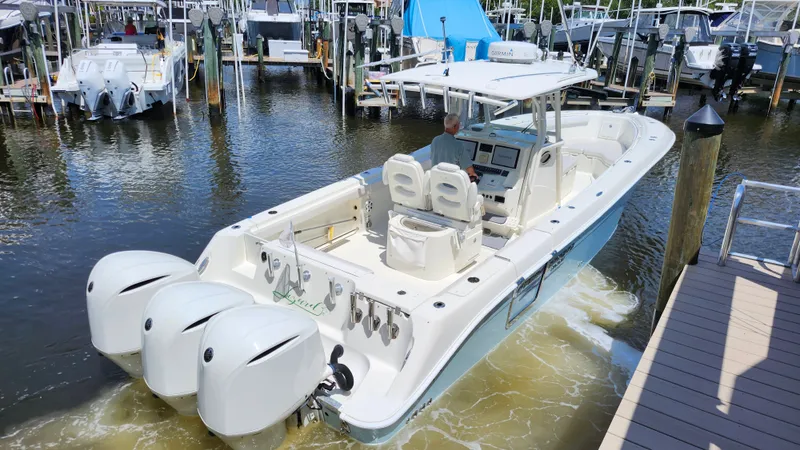 Slide: The Image of 2014 Hydra-Sports 3400 CC boat docked with triple outboard engines. - 5