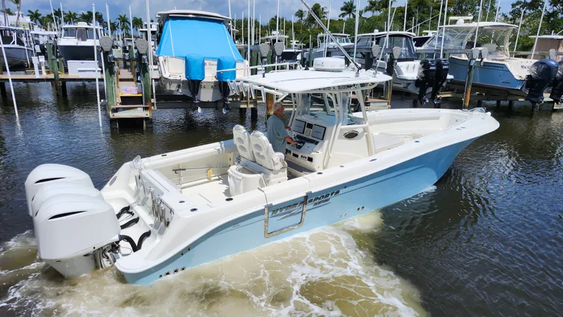 Slide: The Image of 2014 Hydra-Sports 3400 CC boat in harbor, blue and white design. - 6