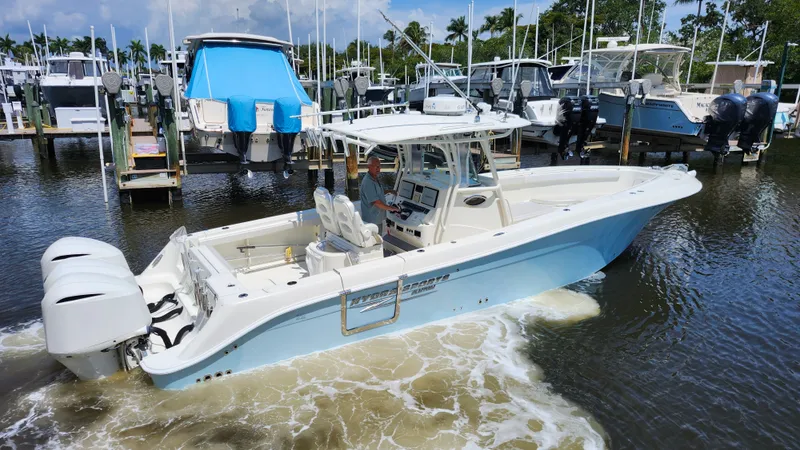 Slide: The Image of 2014 Hydra-Sports 3400 CC boat in harbor, featuring twin outboard engines. - 7