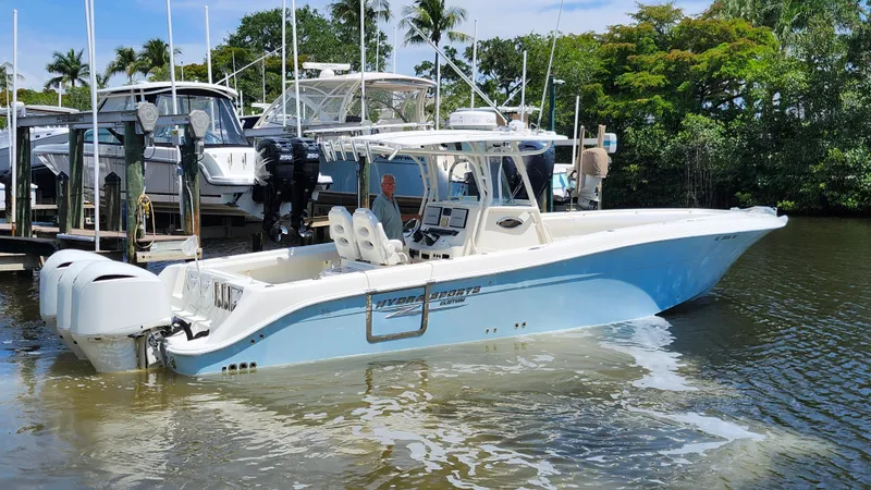 Slide: The Image of 2014 Hydra-Sports 3400 CC boat on water, featuring triple outboard engines. - 8