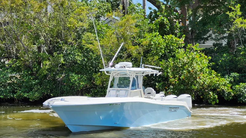 Slide: The Image of 2014 Hydra-Sports 3400 CC boat on calm water near trees. - 9