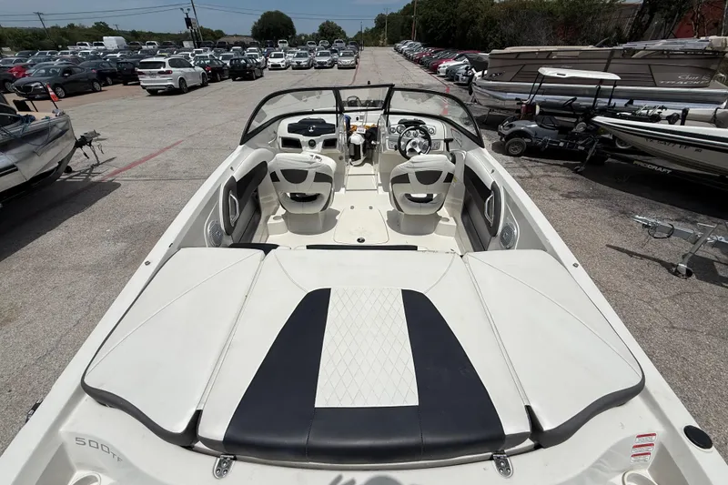 Slide: The Image of 2016 Tahoe 500 TF boat interior with seating and steering wheel, parked among other boats. - 19