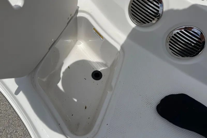 Slide: The Image of Storage compartment in a 2016 Tahoe 500 TF boat, featuring drainage and ventilation grilles. - 22