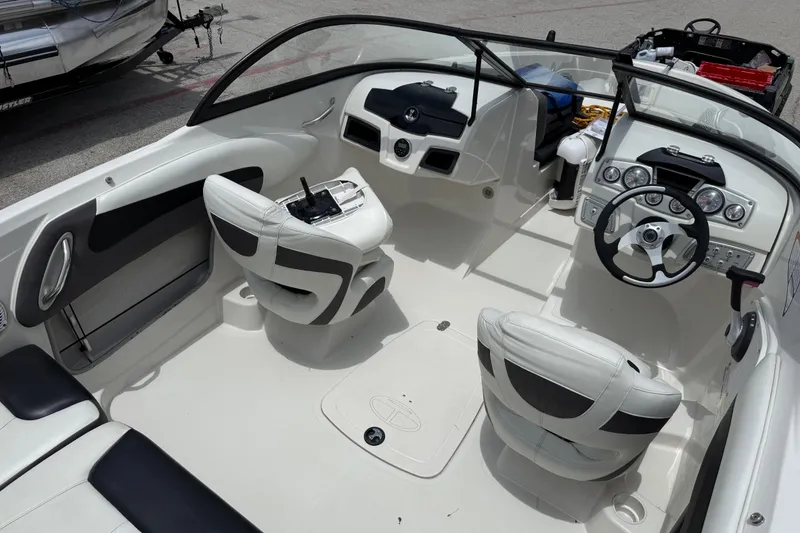 Slide: The Image of Interior of a 2016 Tahoe 500 TF boat, featuring sleek white seating and modern dashboard controls. - 27