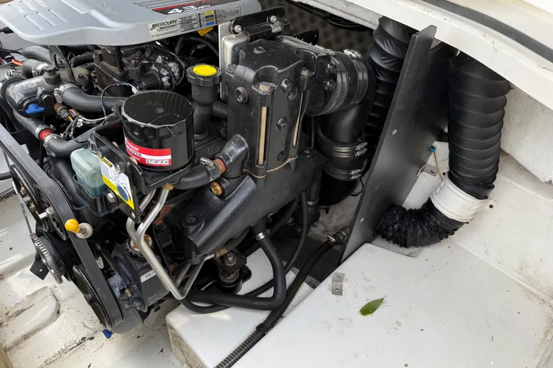 Slide: The Image of Engine compartment of a 2016 Tahoe 500 TF boat, showcasing detailed mechanical components. - 35