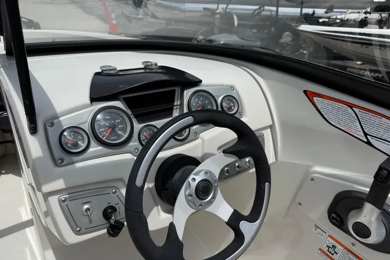 Slide: The Image of Dashboard of a 2016 Tahoe 500 TF boat with steering wheel and gauges. - 36