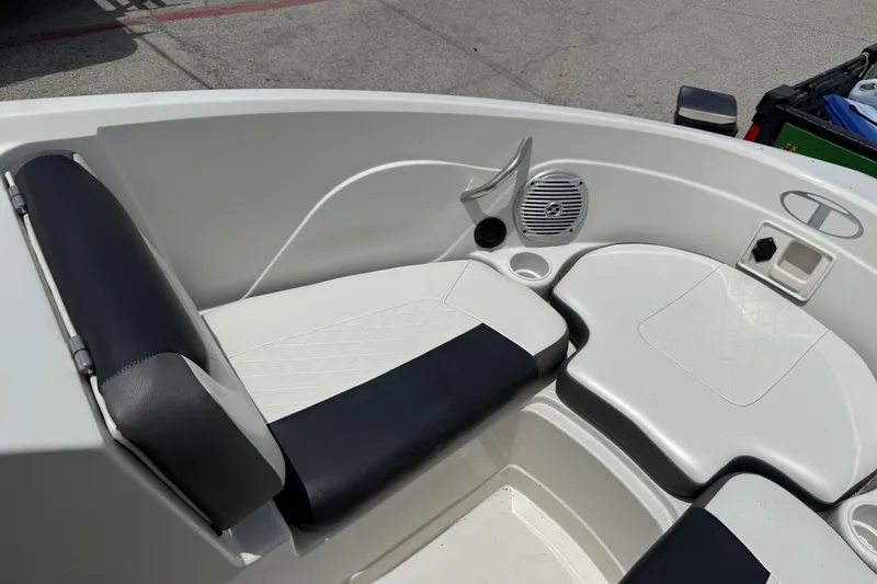 Slide: The Image of Interior of a 2016 Tahoe 500 TF boat featuring cushioned seating and speaker system. - 39