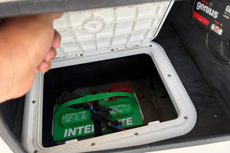Slide: The Image of Hand opening battery compartment of 2016 Tahoe 500 TF, revealing green Interstate battery. - 41