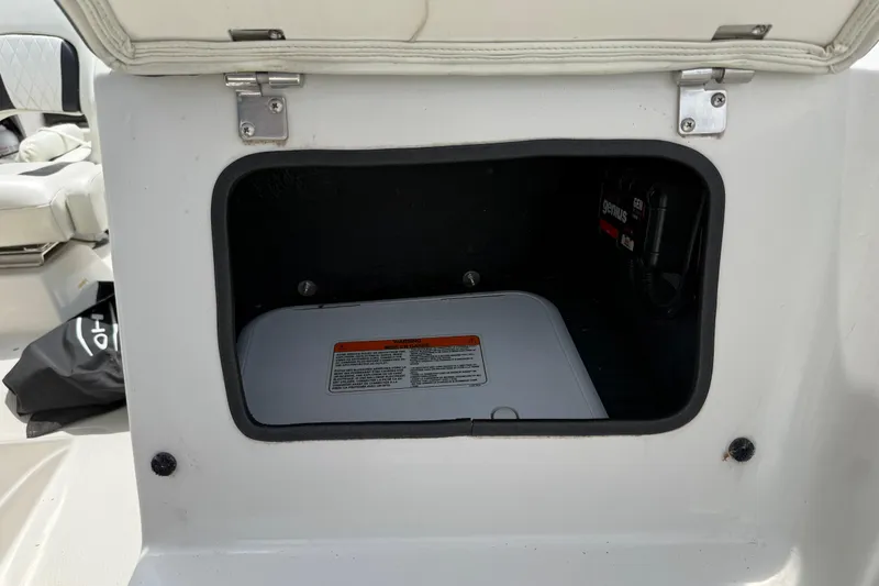 Slide: The Image of Open storage compartment in a 2016 Tahoe 500 TF boat, showing interior details. - 43