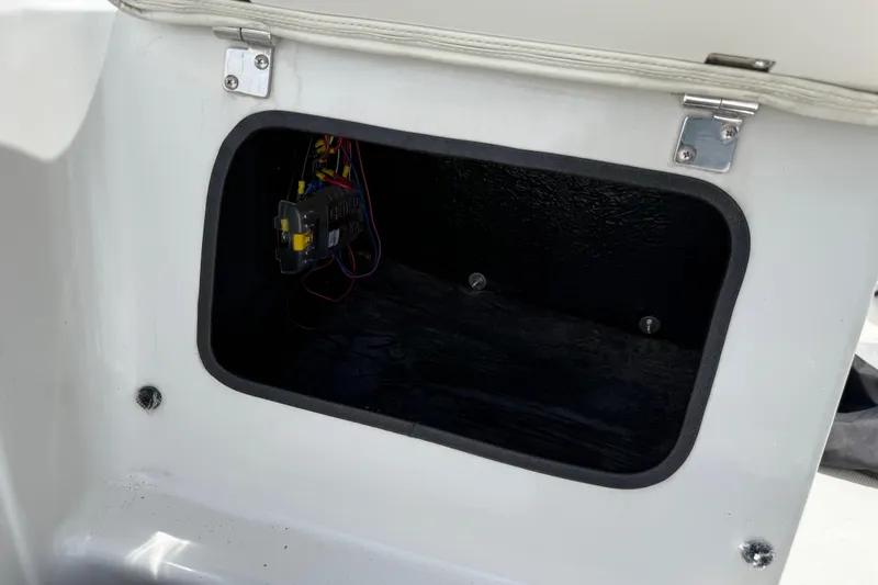 Slide: The Image of Open storage compartment in 2016 Tahoe 500 TF boat, showing wiring and interior details. - 45