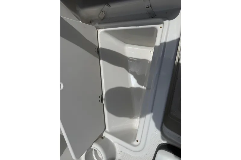 Slide: The Image of Open storage compartment in a 2016 Tahoe 500 TF boat. - 46