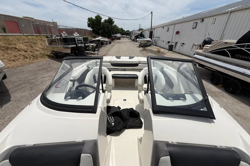 Slide: The Image of 2016 Tahoe 500 TF boat interior with open windshield, parked in a marina. - 47