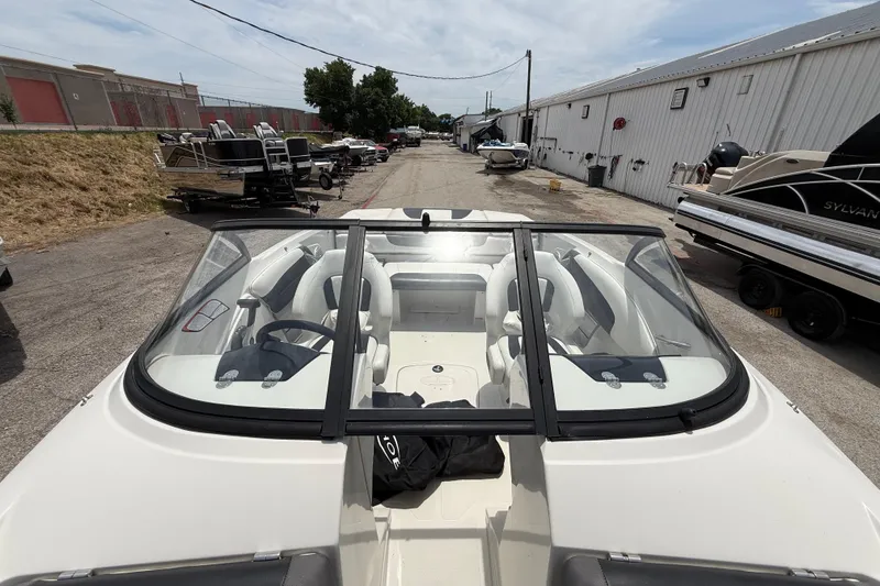 Slide: The Image of 2016 Tahoe 500 TF boat with sleek interior, parked in a marina lot. - 48