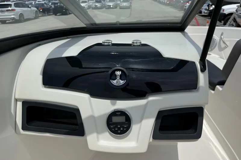 Slide: The Image of Dashboard of a 2016 Tahoe 500 TF boat with sleek black and white design. - 49