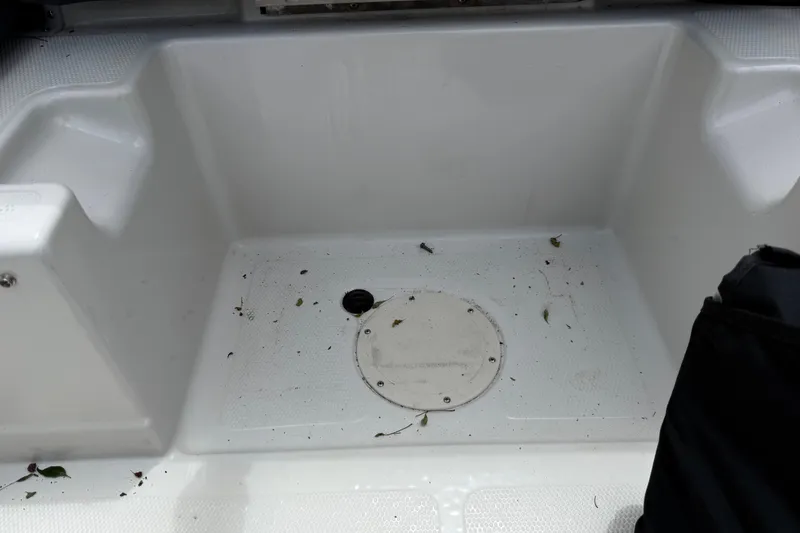 Slide: The Image of Interior of a 2016 Tahoe 500 TF boat with debris on the floor. - 57
