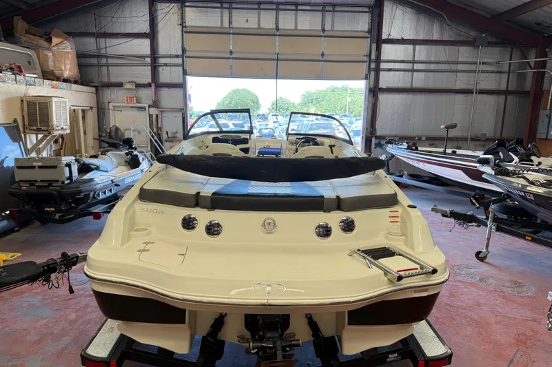 Slide: The Image of 2016 Tahoe 500 TF boat in a garage with other watercraft. - 59