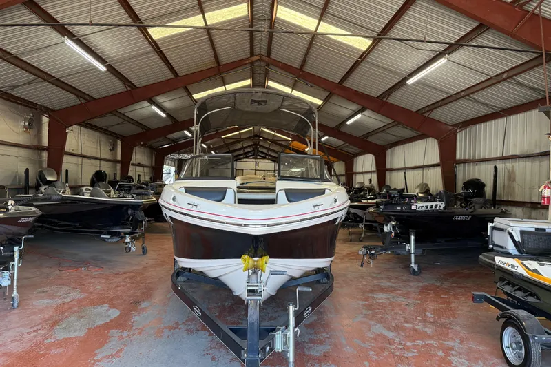 Slide: The Image of 2016 Tahoe 500 TF boat in a spacious indoor storage facility. - 63