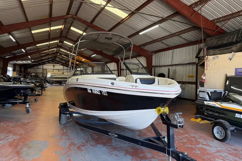 Slide: The Image of 2016 Tahoe 500 TF boat in a spacious indoor storage facility. - 64