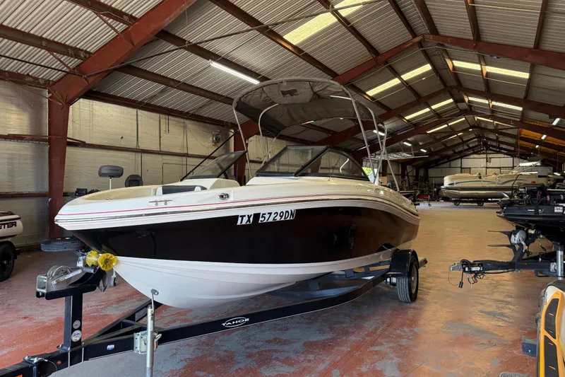 Slide: The Image of 2016 Tahoe 500 TF boat in storage facility, on trailer, under metal roof. - 67