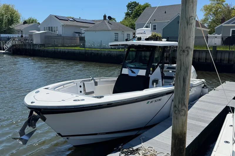 The Image of 2020 Blackfin 272 CC boat docked by waterfront homes on a sunny day. - 1
