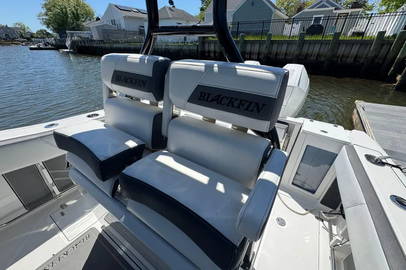 Slide: The Image of 2020 Blackfin 272 CC boat seats by the water, showcasing luxury and comfort. - 13