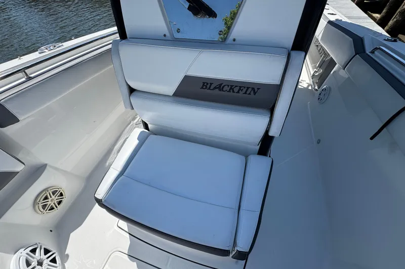 Slide: The Image of 2020 Blackfin 272 CC boat seat with logo, featuring sleek white and gray design. - 17