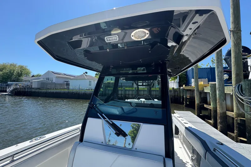 Slide: The Image of 2020 Blackfin 272 CC boat docked, showcasing sleek design and spacious interior. - 18