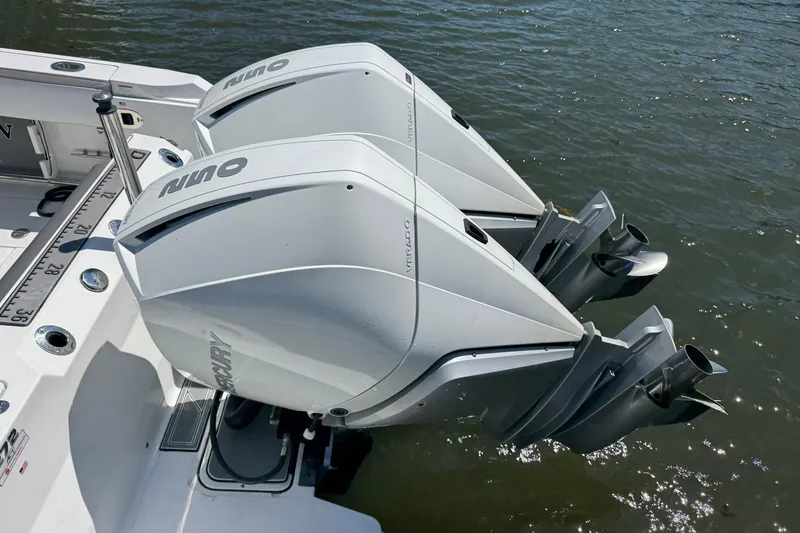 Slide: The Image of Twin outboard engines on a 2020 Blackfin 272 CC boat, floating on water. - 2