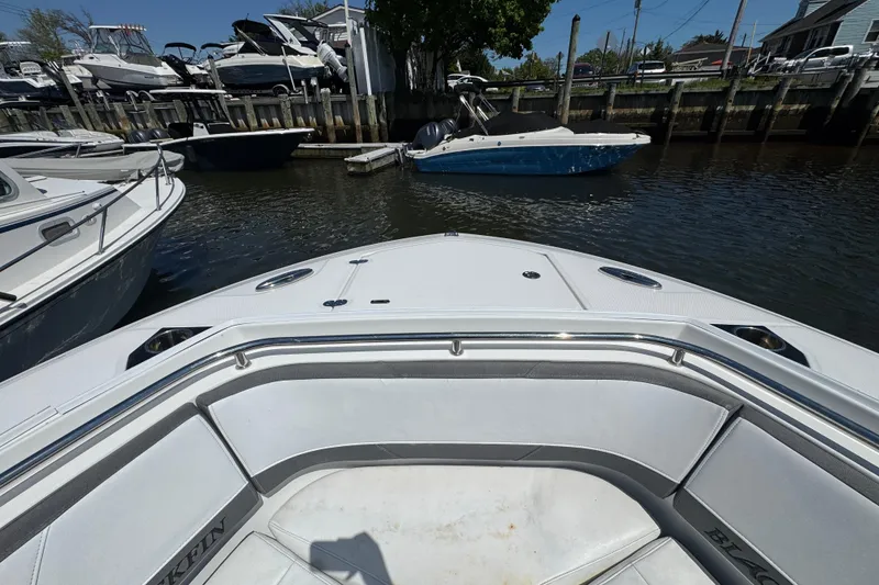 Slide: The Image of 2020 Blackfin 272 CC boat docked in a marina with other vessels. - 22