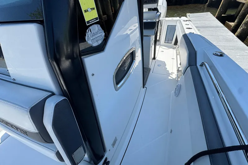 Slide: The Image of 2020 Blackfin 272 CC boat interior with seating and dock view. - 24