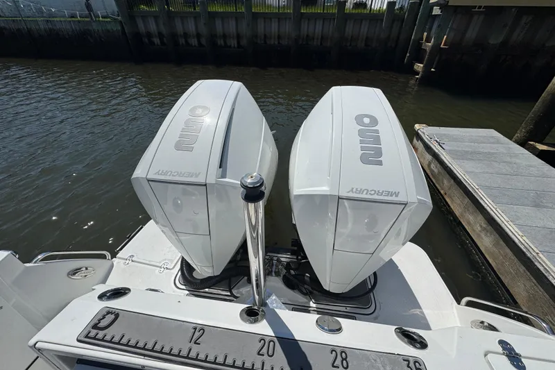 Slide: The Image of Twin Mercury outboard engines on a 2020 Blackfin 272 CC boat at a dock. - 27