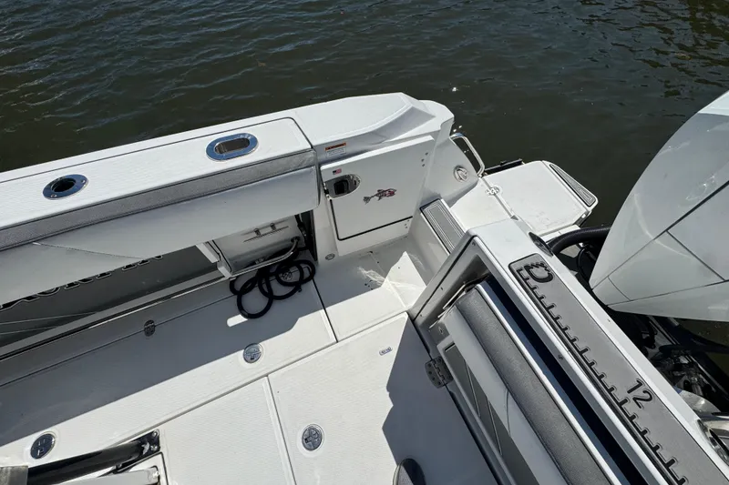 Slide: The Image of 2020 Blackfin 272 CC boat deck with fishing rod holders and storage compartments. - 28