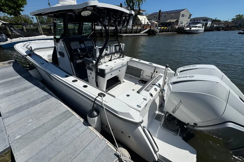 Slide: The Image of 2020 Blackfin 272 CC boat docked, featuring dual Mercury outboard engines. - 3