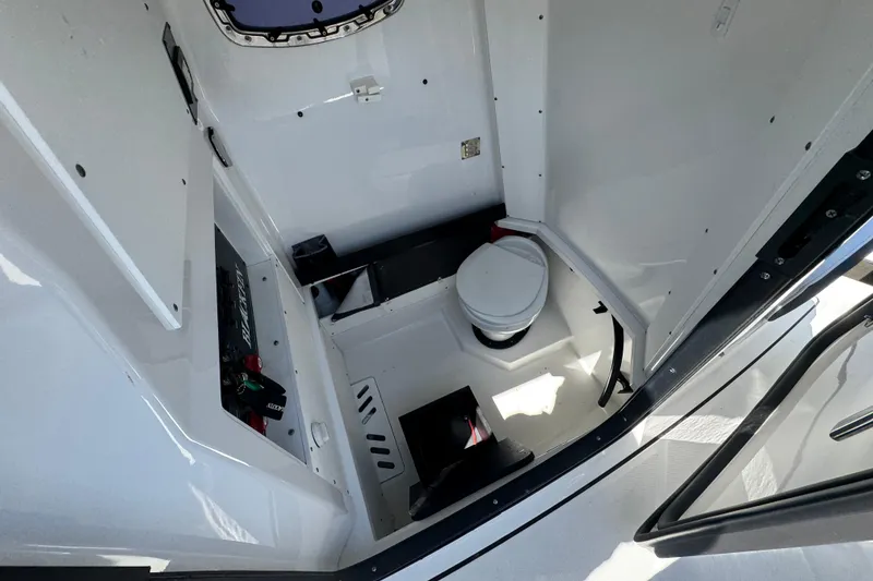 Slide: The Image of 2020 Blackfin 272 CC boat interior with compact marine toilet and storage area. - 32