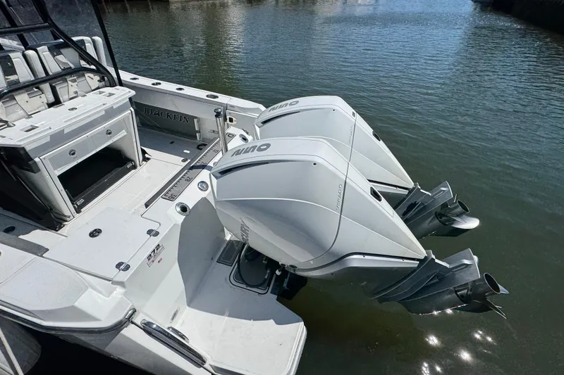 Slide: The Image of 2020 Blackfin 272 CC boat with dual outboard engines on calm water. - 37