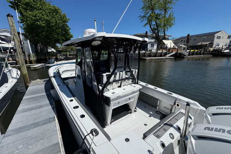Slide: The Image of 2020 Blackfin 272 CC boat docked at marina, featuring sleek design and modern equipment. - 38
