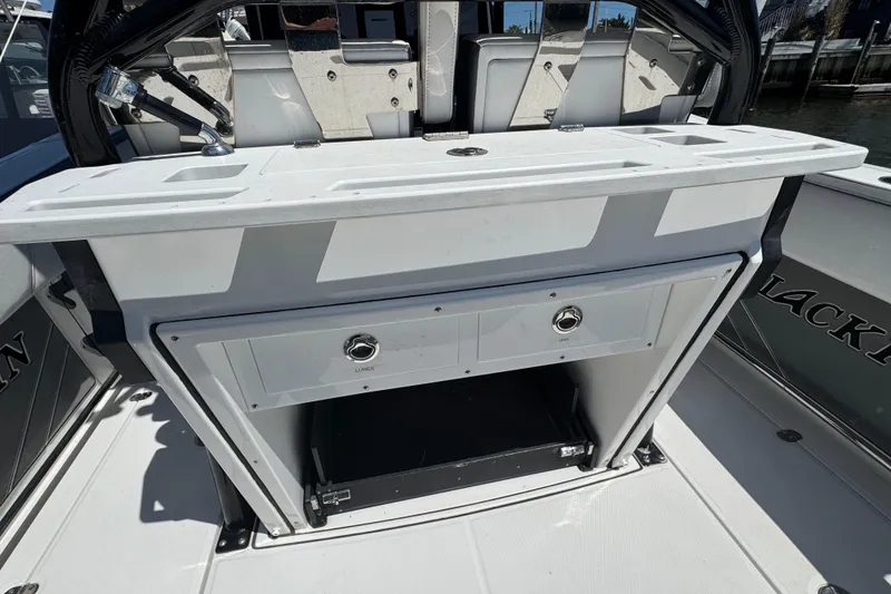 Slide: The Image of 2020 Blackfin 272 CC boat interior with storage compartment and seating area. - 5
