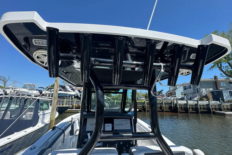 Slide: The Image of 2020 Blackfin 272 CC boat with T-top and rod holders, docked in a marina. - 7