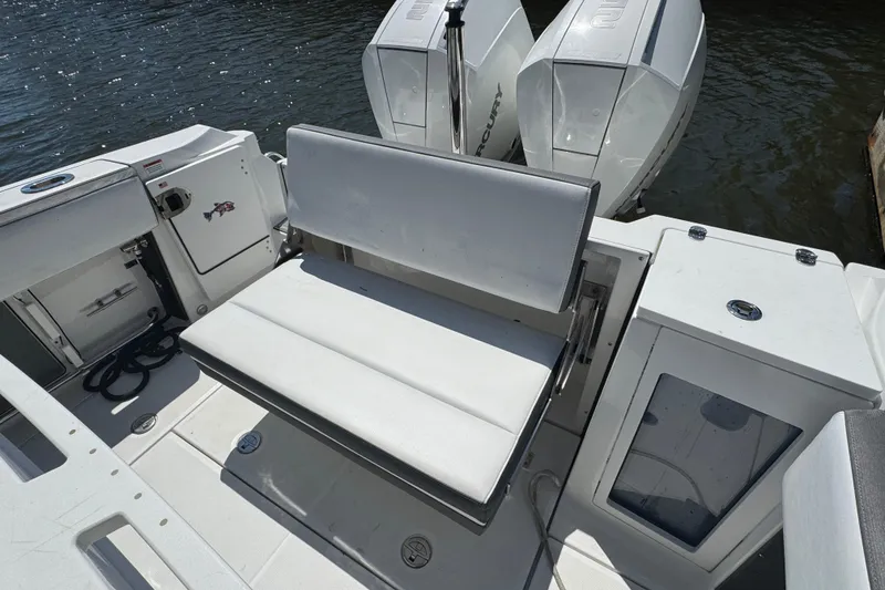 Slide: The Image of 2020 Blackfin 272 CC boat interior with seating and dual Mercury engines. - 8