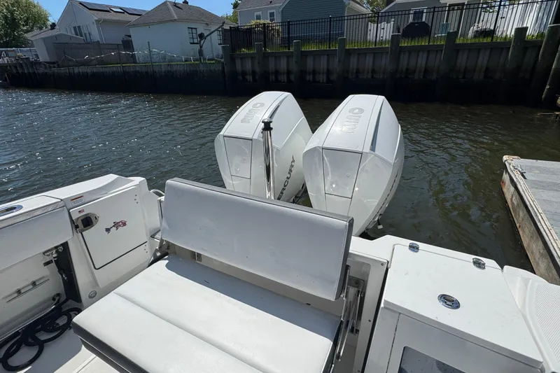 Slide: The Image of 2020 Blackfin 272 CC boat with dual Mercury outboard engines docked by waterfront homes. - 9
