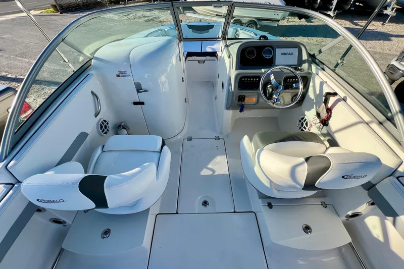 Slide: The Image of 2024 Robalo R207 Dual Console boat interior with steering wheel and seating. - 11