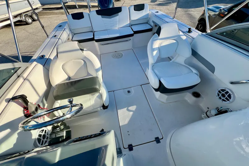 Slide: The Image of 2024 Robalo R207 Dual Console boat interior with seating and steering wheel. - 17