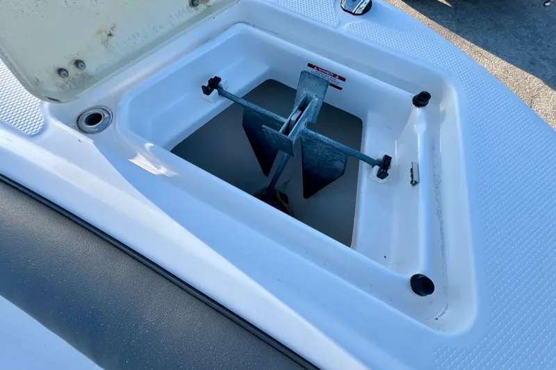 Slide: The Image of Anchor storage compartment on 2024 Robalo R207 Dual Console boat. - 22