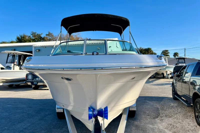 Slide: The Image of 2024 Robalo R207 Dual Console boat on trailer, front view, sunny day. - 3