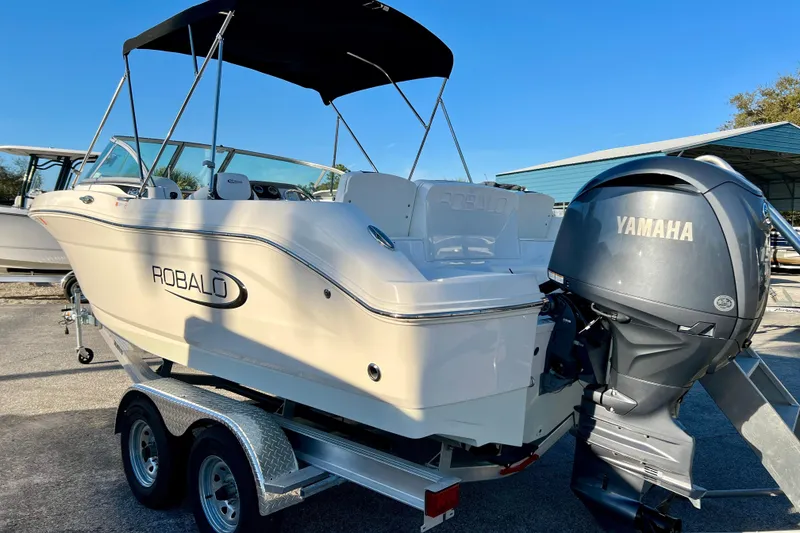 Slide: The Image of 2024 Robalo R207 Dual Console boat with Yamaha engine on trailer, outdoor display. - 5