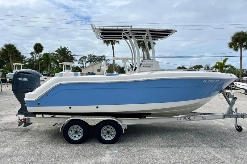 The Image of 2024 Robalo R222 Center Console boat on trailer, featuring Yamaha engine. - 1