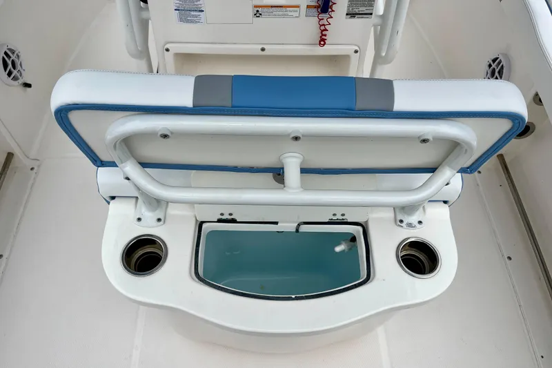 Slide: The Image of 2024 Robalo R222 Center Console boat seat with storage and cup holders. - 10