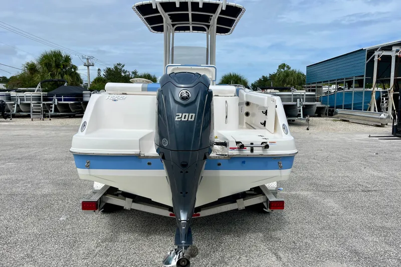 Slide: The Image of 2024 Robalo R222 Center Console boat with Yamaha 200 engine, parked outdoors. - 7
