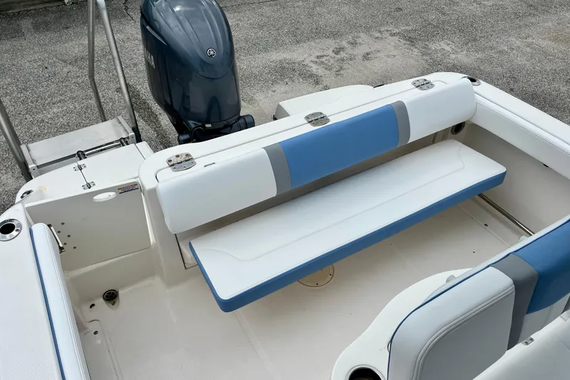 Slide: The Image of 2024 Robalo R222 Center Console boat with blue and white seating and Yamaha outboard motor. - 9
